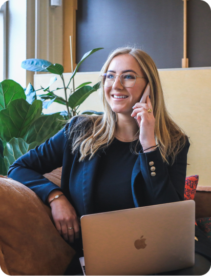 A lady on phone, working and smiling